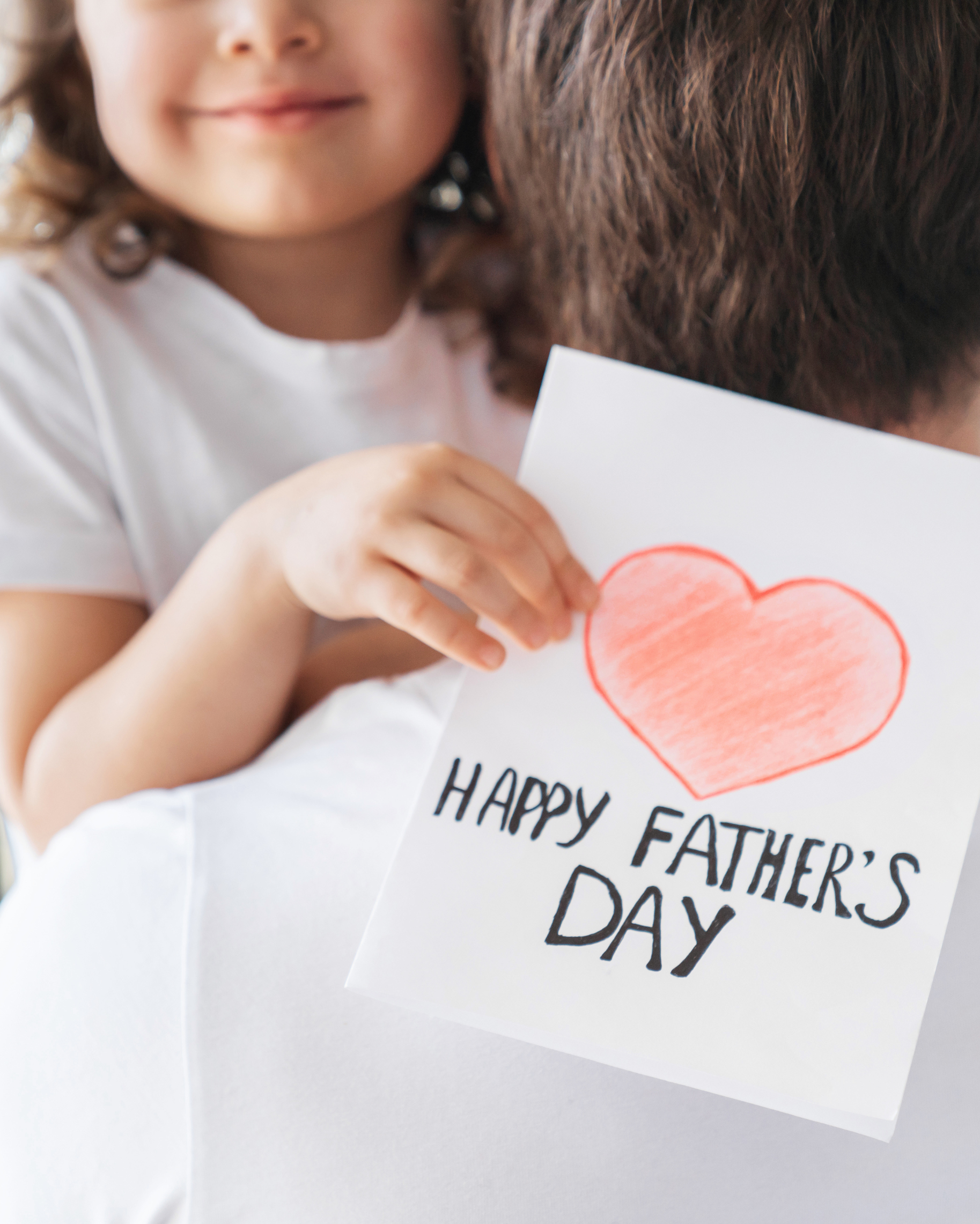 Father and daughter celebrating Father's day with a hug