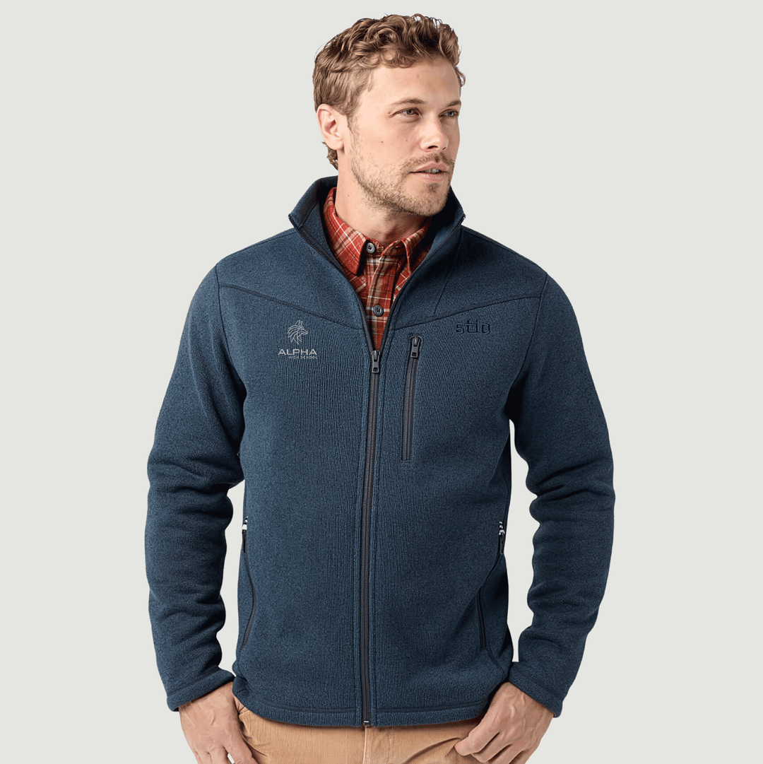 Man wearing a blue fleece jacket with visible branding on a light gray background